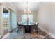 Bright dining room with modern chandelier, large window, and sliding doors to the backyard at 4171 Canopy Creek Dr, Denver, NC 28037