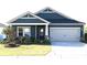 Charming one story home with blue siding, stone accents, manicured lawn, and attached two car garage at 4171 Canopy Creek Dr, Denver, NC 28037