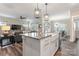 Modern kitchen with granite countertops, farmhouse sink, and stainless steel appliances at 4171 Canopy Creek Dr, Denver, NC 28037
