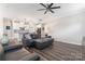 Open living area features hardwood floors, a ceiling fan, and connects to the modern kitchen at 4171 Canopy Creek Dr, Denver, NC 28037