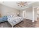 Spacious main bedroom with tray ceiling, hardwood floors, a ceiling fan, and ensuite bath at 4171 Canopy Creek Dr, Denver, NC 28037