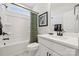 Well-lit bathroom with a white vanity, tub-shower, and modern fixtures, and light colored walls at 424 Balboa St, Matthews, NC 28104