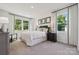 Calming bedroom with neutral tones, soft carpet, and bright windows offering outdoor views at 424 Balboa St, Matthews, NC 28104