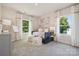 Sunlit bedroom featuring plush carpet, a cozy daybed, and bright windows with views of backyard at 424 Balboa St, Matthews, NC 28104