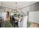 Open dining room with modern furnishings, stylish table settings, and wainscotting for a bright, airy feel at 424 Balboa St, Matthews, NC 28104