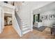 Elegant foyer with an open staircase, wood floors, designer finishes, and an open view into an office at 424 Balboa St, Matthews, NC 28104