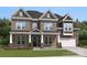 Charming two-story home featuring a brick facade, covered entrance, and well-manicured lawn at 424 Balboa St, Matthews, NC 28104