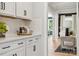 Bright kitchen with white cabinetry, quartz countertops, textured backsplash, and modern black hardware at 424 Balboa St, Matthews, NC 28104
