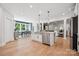 Open-concept kitchen with stainless steel appliances and connected to a dining area and living room at 424 Balboa St, Matthews, NC 28104