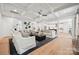 Bright living room featuring coffered ceilings, hardwood floors, and an open layout with kitchen view at 424 Balboa St, Matthews, NC 28104