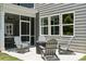 Outdoor patio with seating area including Adirondack chairs and a screened-in porch for seamless indoor-outdoor living at 424 Balboa St, Matthews, NC 28104