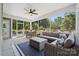 Well-furnished screened porch with an oversized sectional sofa, and adjacent dining area, perfect for outdoor relaxation at 424 Balboa St, Matthews, NC 28104