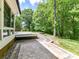 Expansive backyard with a stone path, deck, and lush greenery at 4301 Middle Stream Rd, Charlotte, NC 28213
