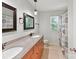 Elegant bathroom with dual sinks, granite countertop, decorative mirrors, and shower at 4301 Middle Stream Rd, Charlotte, NC 28213