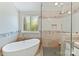 Luxurious bathroom featuring a soaking tub, glass-enclosed shower, and elegant tile work at 4301 Middle Stream Rd, Charlotte, NC 28213