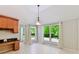 Bright breakfast nook with large windows, tiled floors, and views of the landscaped backyard at 4301 Middle Stream Rd, Charlotte, NC 28213