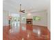 Spacious living room with a fireplace, hardwood floors, and open access to the kitchen at 4301 Middle Stream Rd, Charlotte, NC 28213