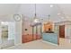 Open-concept living room with hardwood floors, a barn door and modern lighting fixtures at 4301 Middle Stream Rd, Charlotte, NC 28213