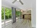 Bright living room with hardwood floors and large windows overlooking the backyard at 4301 Middle Stream Rd, Charlotte, NC 28213