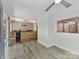 Open living room with hardwood floors and large windows overlooking the backyard at 4301 Middle Stream Rd, Charlotte, NC 28213