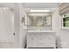 Bright bathroom featuring a double vanity with marble countertop and decorative mirrors at 4360 Woodglen Ln, Charlotte, NC 28226