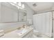 Bright bathroom featuring a sink, toilet, vanity, mirror, and shower at 4360 Woodglen Ln, Charlotte, NC 28226