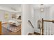 View from hallway into bedroom with king bed and neutral decor, next to stairs at 4360 Woodglen Ln, Charlotte, NC 28226