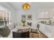 Bright breakfast nook with banquette seating and adjacent to kitchen at 4360 Woodglen Ln, Charlotte, NC 28226