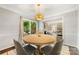 Dining area featuring a round table, comfortable chairs, and natural light, blending seamlessly with the living space at 4360 Woodglen Ln, Charlotte, NC 28226