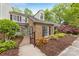A beautiful home featuring a landscaped yard, a brick exterior, and black shutters at 4360 Woodglen Ln, Charlotte, NC 28226