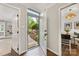 Inviting foyer with wood floors and a view of the landscaped front yard through the open front door at 4360 Woodglen Ln, Charlotte, NC 28226