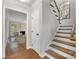 Inviting hallway with hardwood floors, stairs, and view into living room with fireplace at 4360 Woodglen Ln, Charlotte, NC 28226