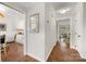 Hallway featuring hardwood floors leading to the kitchen, living room, and bedrooms at 4360 Woodglen Ln, Charlotte, NC 28226