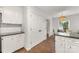 Kitchen area with white cabinets, granite countertops, and nearby dining space at 4360 Woodglen Ln, Charlotte, NC 28226