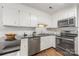 Bright kitchen featuring white cabinets, stainless steel appliances, and modern finishes at 4360 Woodglen Ln, Charlotte, NC 28226