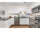 Kitchen with stainless steel appliances, white cabinetry and subway tile backsplash at 4360 Woodglen Ln, Charlotte, NC 28226