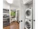 Laundry area with stacked washer and dryer units located near kitchen at 4360 Woodglen Ln, Charlotte, NC 28226