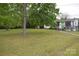 Charming single-story home with a well-maintained lawn and mature trees, creating a serene setting at 4671 Lucas Ct, Harrisburg, NC 28075
