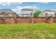 This backyard features a grassy area and brick and metal fencing at 5030 Ashley Place Dr, Bessemer City, NC 28016
