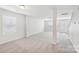 Open living room features neutral carpet and natural light at 5030 Ashley Place Dr, Bessemer City, NC 28016
