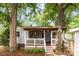 Charming back porch with cozy seating and hanging plants is perfect for enjoying the outdoors at 506 Englewood Ne St, Concord, NC 28025
