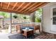 Charming covered back porch with comfortable seating and neighborhood views, perfect for outdoor relaxation at 506 Englewood Ne St, Concord, NC 28025