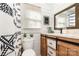 Well-lit bathroom featuring modern fixtures, shiplap walls, and a stylish vanity with a wooden frame at 506 Englewood Ne St, Concord, NC 28025