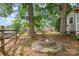 Backyard fire pit surrounded by seating and lush landscaping provides a cozy outdoor gathering space at 506 Englewood Ne St, Concord, NC 28025