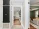 Bright hallway with hardwood floors, with a view into the Primary bedroom at the end of the hall at 506 Englewood Ne St, Concord, NC 28025