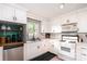 Bright kitchen featuring white cabinets, modern appliances, and an undermount stainless sink at 506 Englewood Ne St, Concord, NC 28025