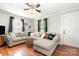 Inviting living room with a comfortable sectional sofa, wood floors, and natural light at 506 Englewood Ne St, Concord, NC 28025