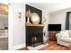 Living room featuring a painted fireplace with a decorative mirror and comfortable seating at 506 Englewood Ne St, Concord, NC 28025