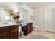 Bathroom with double vanity, dark wood cabinets, and a large mirror at 5106 Stone Park Dr, Charlotte, NC 28269