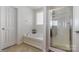 Bright bathroom features a soaking tub, separate glass shower, and tiled floor at 5106 Stone Park Dr, Charlotte, NC 28269